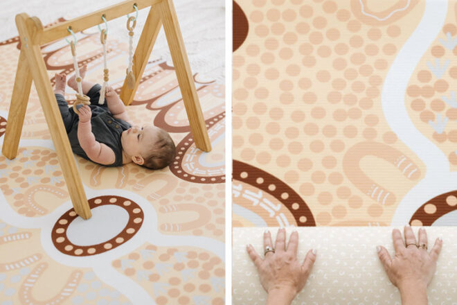 Baby lying under a play bar on a indigenous art play mat by Freddy & Co