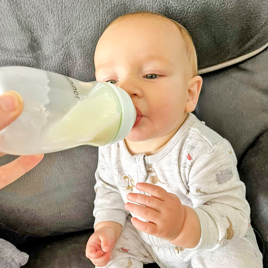 Baby drinking out of Mininor Glass bottle in 240ml