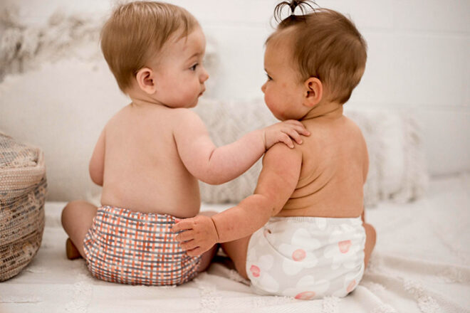 Two babies wearing My Little Gumnut Modern Cloth Nappies showing two neutral designs