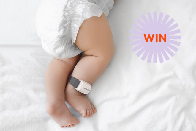 Guardian Plus Baby wearing the Wearable Sleep Tracker + Smart Soother around her ankle in bed