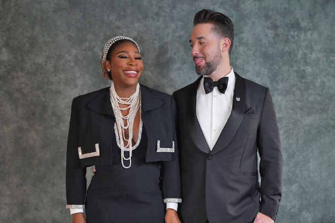 Serena Williams and Alexis Ohanian standing next to eachother in front of a green backdrop