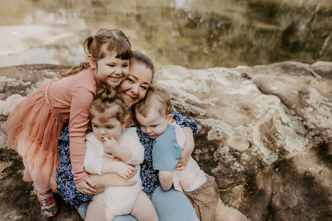 A professional family photoshoot of Stacy and her three kids