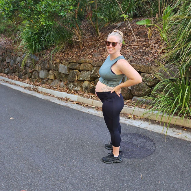 Tegan posing pregnant during walk