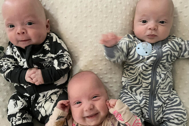 Triplets smiling
