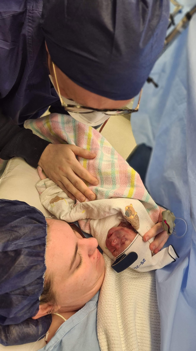 Caitlin gives birth via a c-section