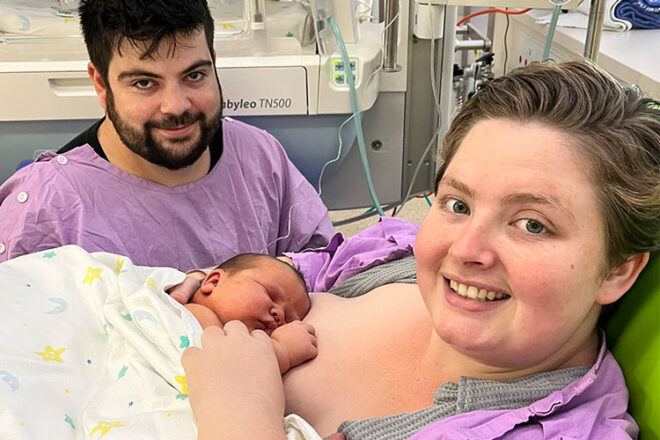 Olivia with her newborn baby boy and partner in hospital.