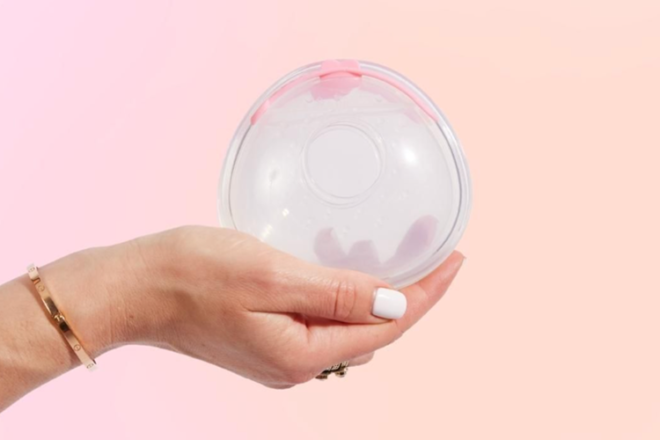 Bubka breast milk catcher in a woman's hand showing size and design