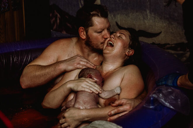Cassaundra, her husband in the birth pool with their newborn baby