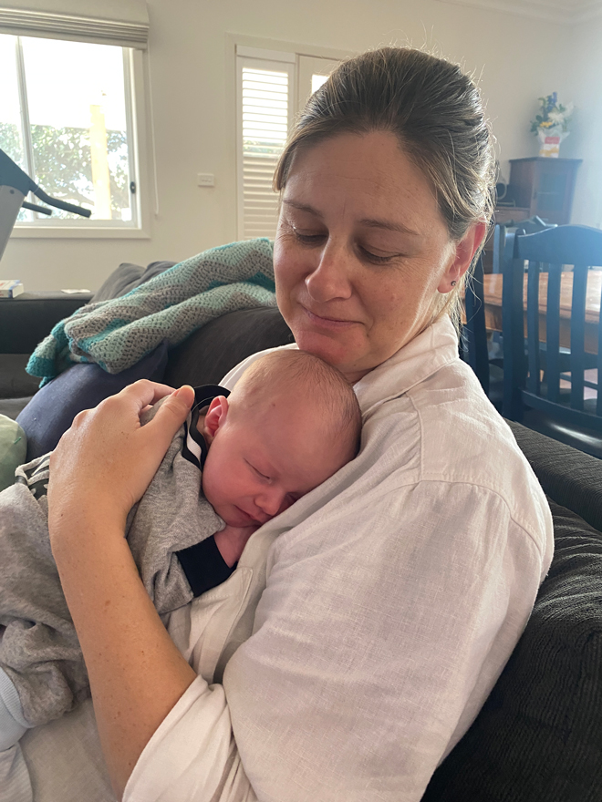 Surrogate holding baby james at home