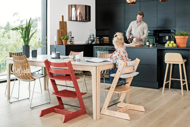 child sitting at the kitchen table on a Stokke Tripp Trapp junior chair