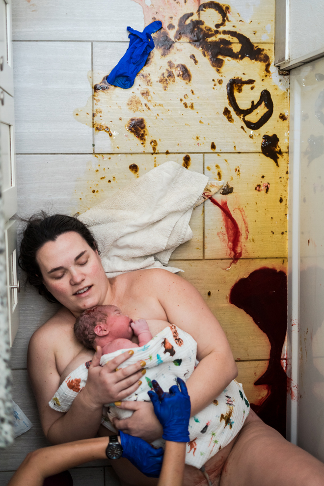 A mother after birth holding her newborn baby