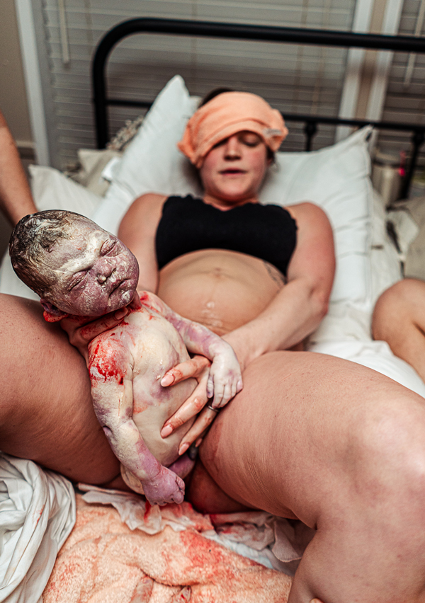 A woman birthing her own baby