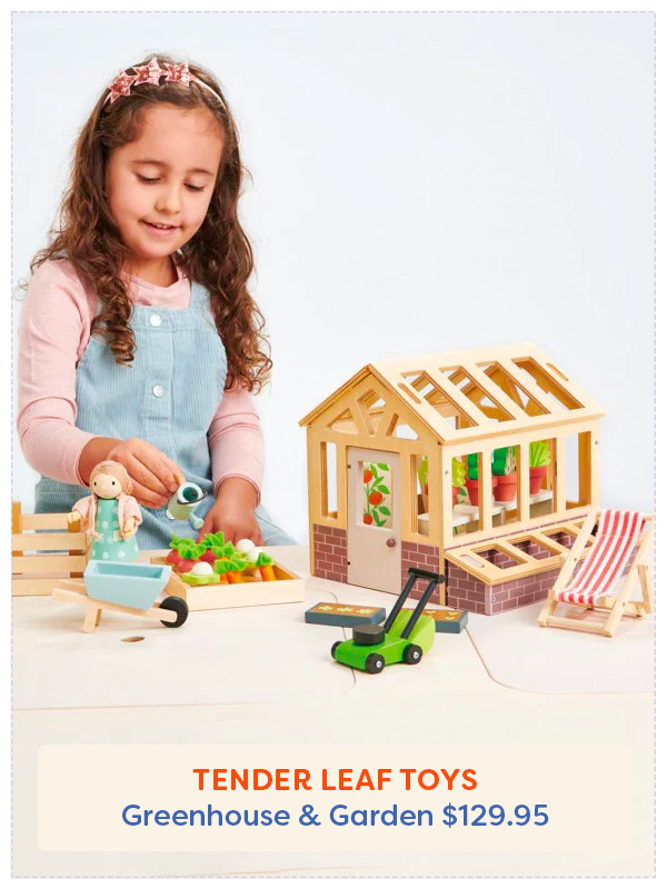 Little girl playing with the Tender Leaf Toys Greenhouse and Garden play set