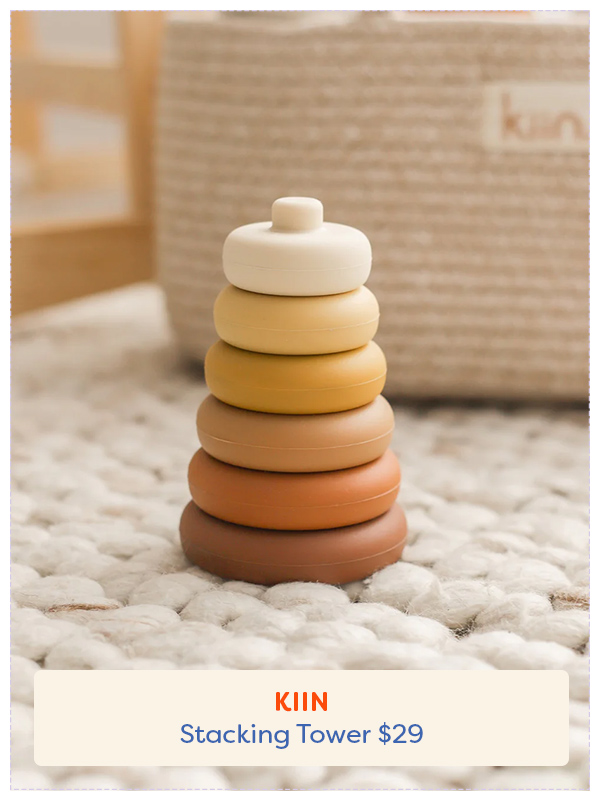 silicone stacking tower toy sitting on carpet in ombre colours