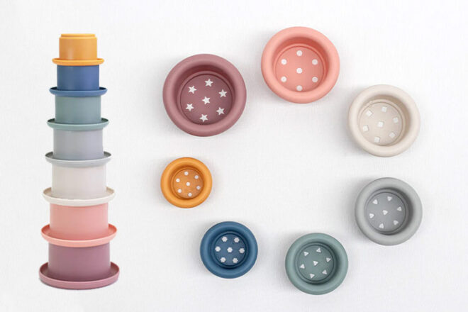 A collection of silicone stacking cups showing height and holes in the bottom of each cup