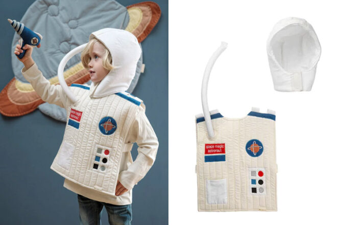 young boy wearing a Fabelab astronaut dress up suit pointing a toy laser beam