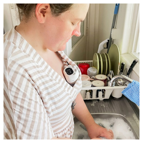 Mum using the Welcare Nurture Wearable Electric Breast Pump while doing the dishes
