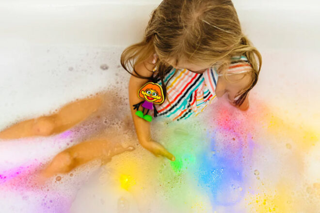 young girl in the bath with Jellystone Designs Glo Pals 