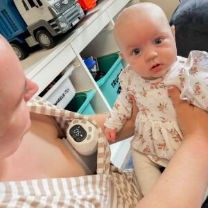 Mum using the Welcare Nurture Wearable Electric Breast Pump while playing with baby