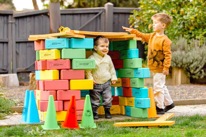 Two children playing with KICKBrick Kick Bricks