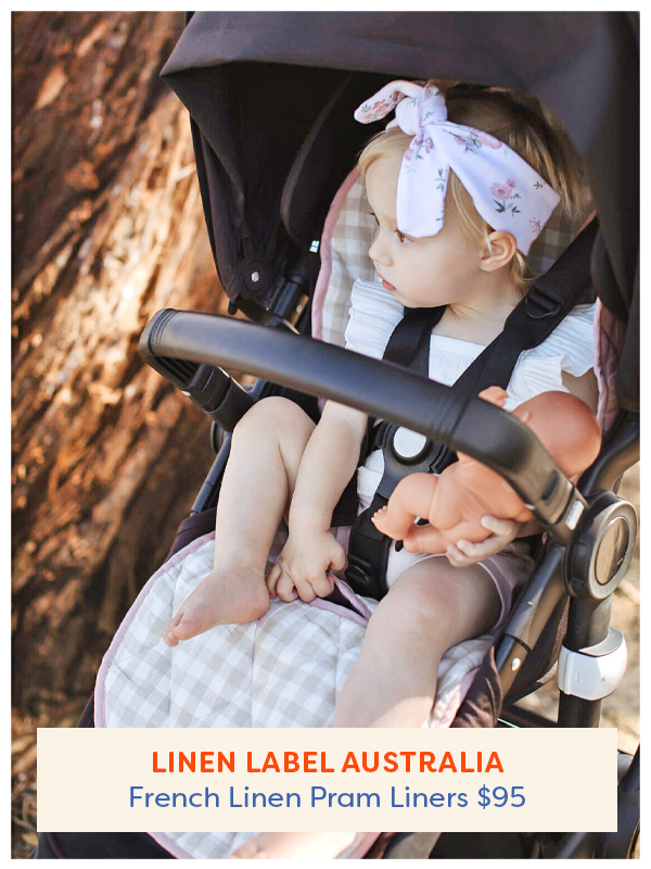 Baby sitting in a pram with the Linen Label Australia French Linen Pram Liner