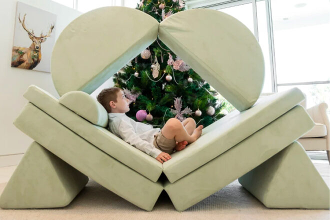Young boy lying in a Loungey Play Couch built as a cubby 