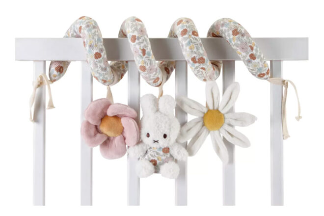 The activity spiral toy on the side of a cot with miffy in the centre