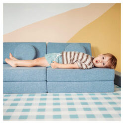 Child laying on the My NooK Junior play couch