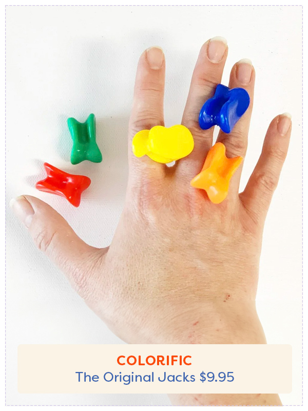 A hand with Jacks toys on them and around them