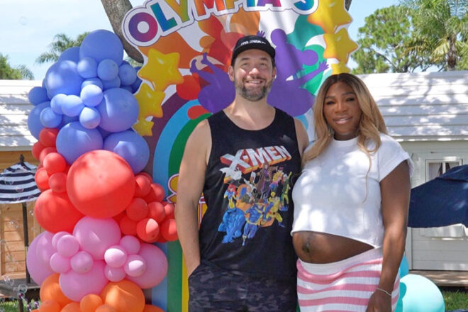 Tennis star Serena Williams standing with her husband Alexis Ohanian in front of a balloon display