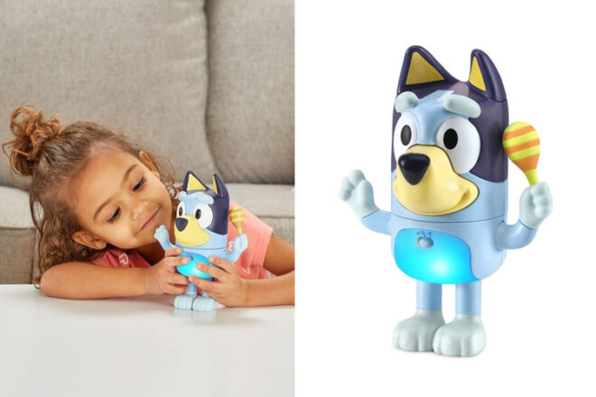 a little girl playing with Shake It Bluey next to the toy