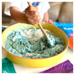 a child mixing together the Wild Dough Playdough Mix