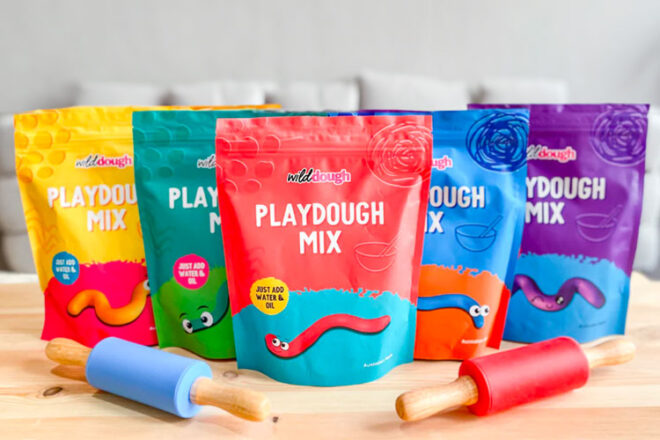 the Wild Dough Playdough Mix in the range of colours it is available in with blue and red rolling pins sitting in front