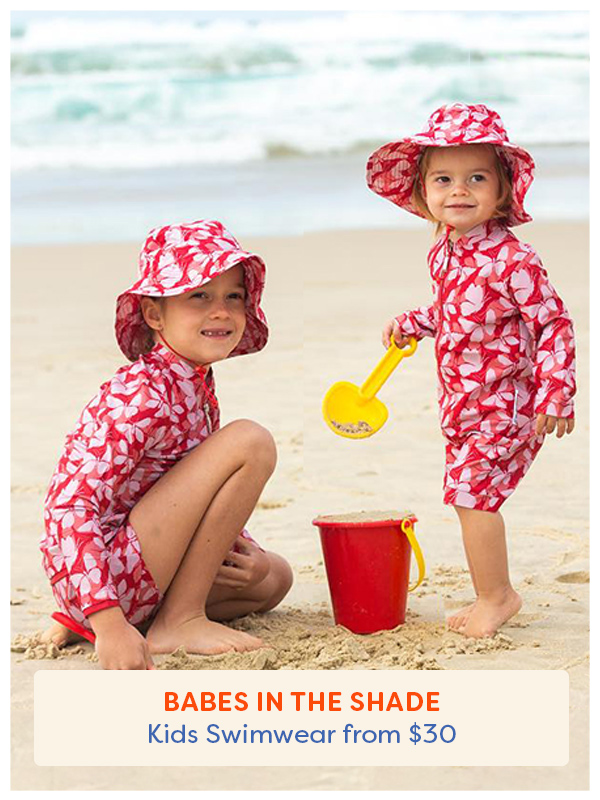 Two girls at the beach wearing matching hats from Babes in the Shade