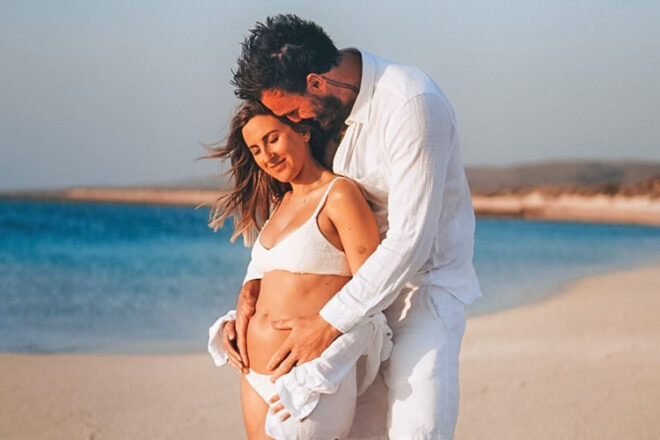 Irena and Locky Gilbert standing on the beach after announcing their pregnancy