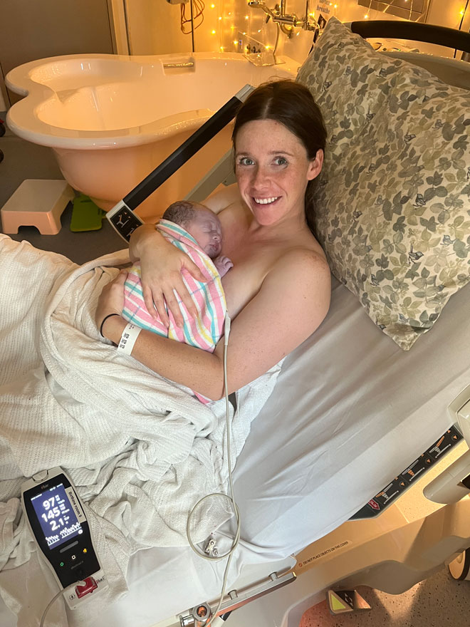 Jacki smiling with her baby after giving birth