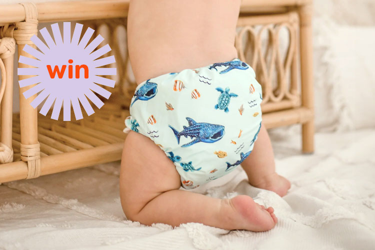 A baby wearing a My Little Gumnut cloth nappy in Marine Life print