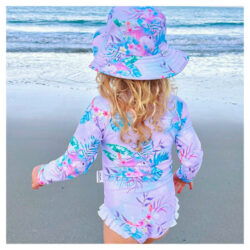 Young girl wearing matching swim hat and long sleeve bathers from Tribe Tropical