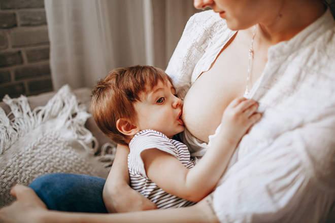 Mother breastfeeding toddler