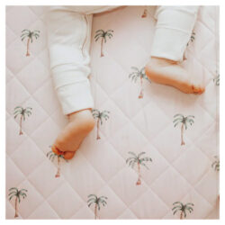 Child laying on the Bambella Designs waterproof cot sheets