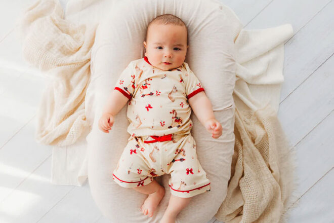 Baby wearing Child of Mine Christmas baby pjs
