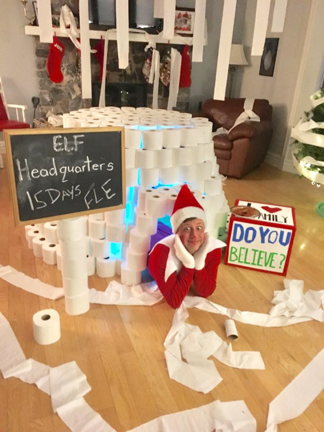 Dad dresses as elf on the shelf under toilet paper igloo