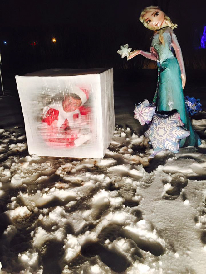 Dad dresses as elf on the shelf hidden inside an ice cube pretending to be frozen by Elsa