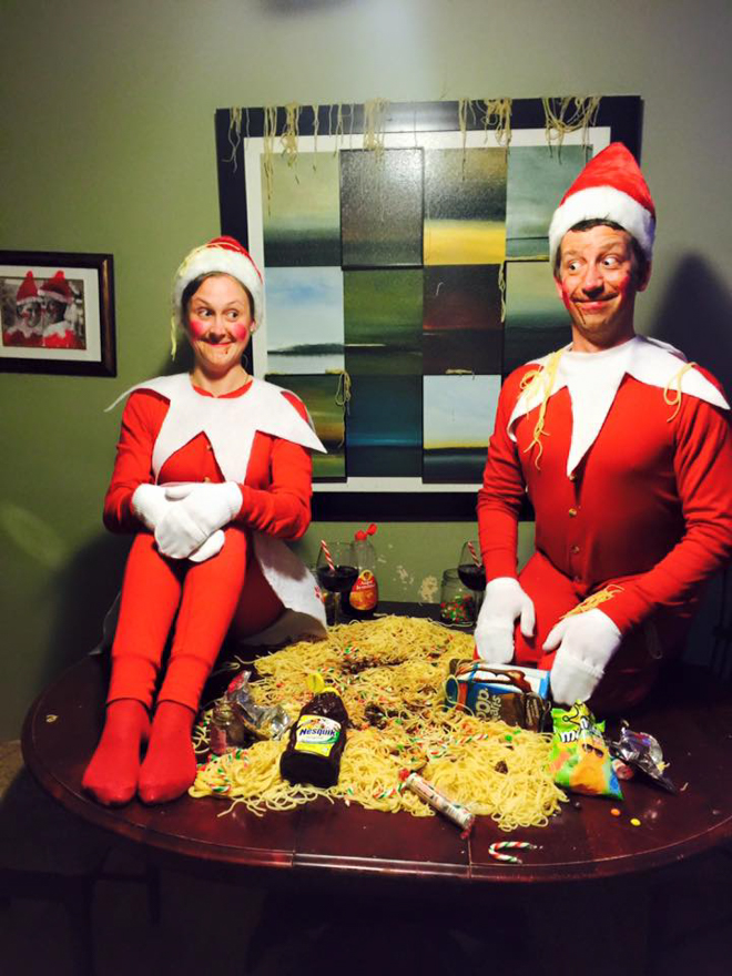 Dad and Mum dresses as elf on the shelf whilst eating Elf style spaghetti with chocolates