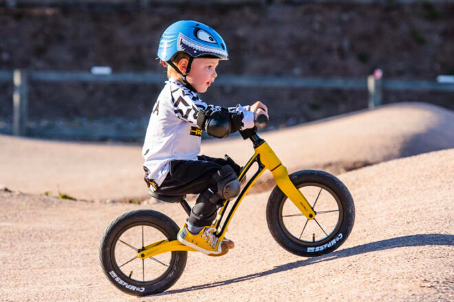 Young boy riding a Hornit balance bike