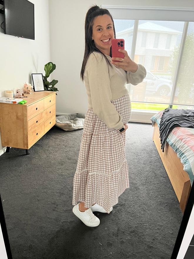 Laura early on in her pregnancy taking a selfie