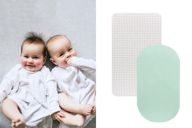 Two babies lying in a cot on grey marle Little Turtle Baby Cot Sheets