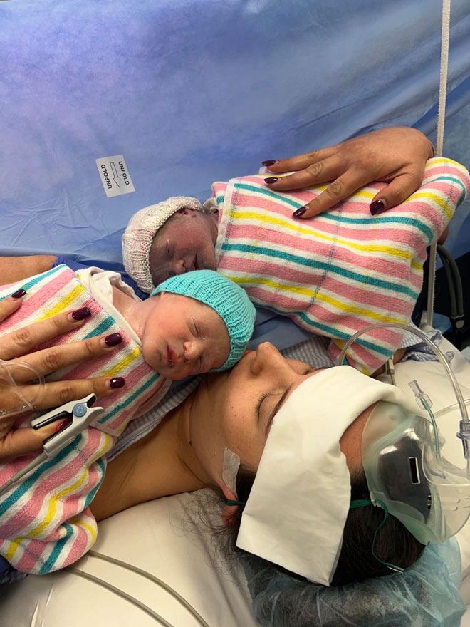 Rebecca holds twins born via c-section