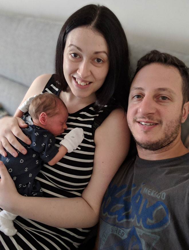 Sally with her husband and baby at home