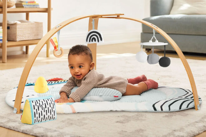 A baby having tummy time using the Skip Hop Activity Gym 